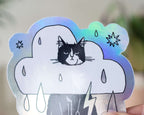 Rain Cloud Cat - Light mode | Holographic Vinyl Stickers of a grumpy Tuxedo Cat in a rain cloud costume