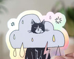 Rain Cloud Cat - Light mode | Holographic Vinyl Stickers of a grumpy Tuxedo Cat in a rain cloud costume
