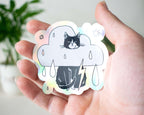 Rain Cloud Cat - Light mode | Holographic Vinyl Stickers of a grumpy Tuxedo Cat in a rain cloud costume