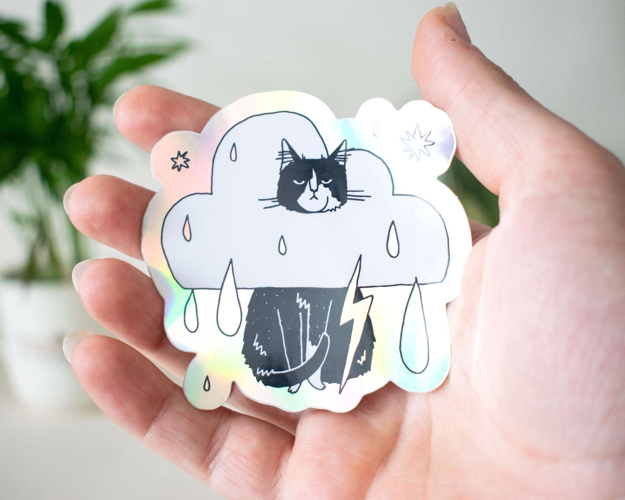 Rain Cloud Cat - Light mode | Holographic Vinyl Stickers of a grumpy Tuxedo Cat in a rain cloud costume