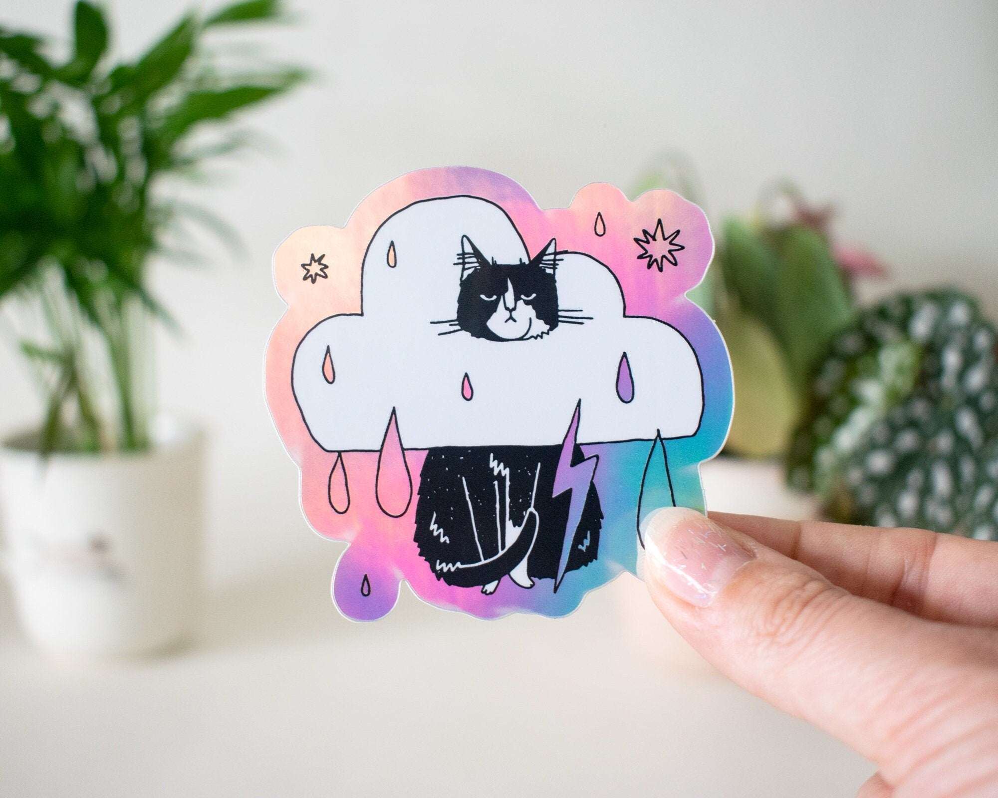Rain Cloud Cat - Light mode | Holographic Vinyl Stickers of a grumpy Tuxedo Cat in a rain cloud costume