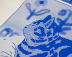 Bliss t-shirt | Hand screen printed on sand/beige organic cotton tee with blue comic style illustration of a tabby cat getting comfy