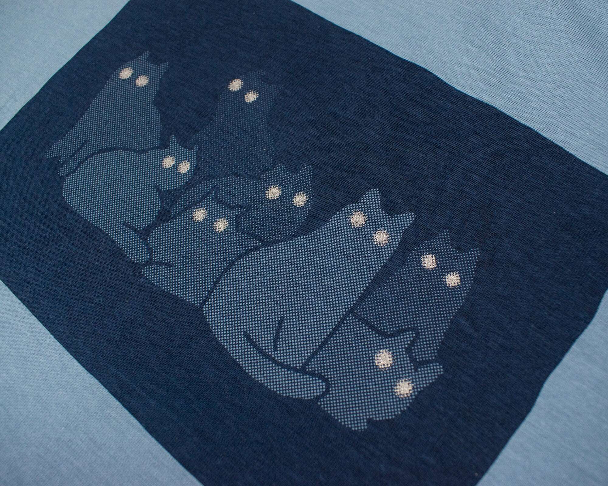 Reflecting cat eyes t-shirt | Hand screen printed on blue organic cotton tee with reflective ink
