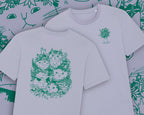 Summer Bouquet T-Shirt | Hand screen printed illustration of 7 cats with flowercrowns and other plants in green on lilac organic cotton tee