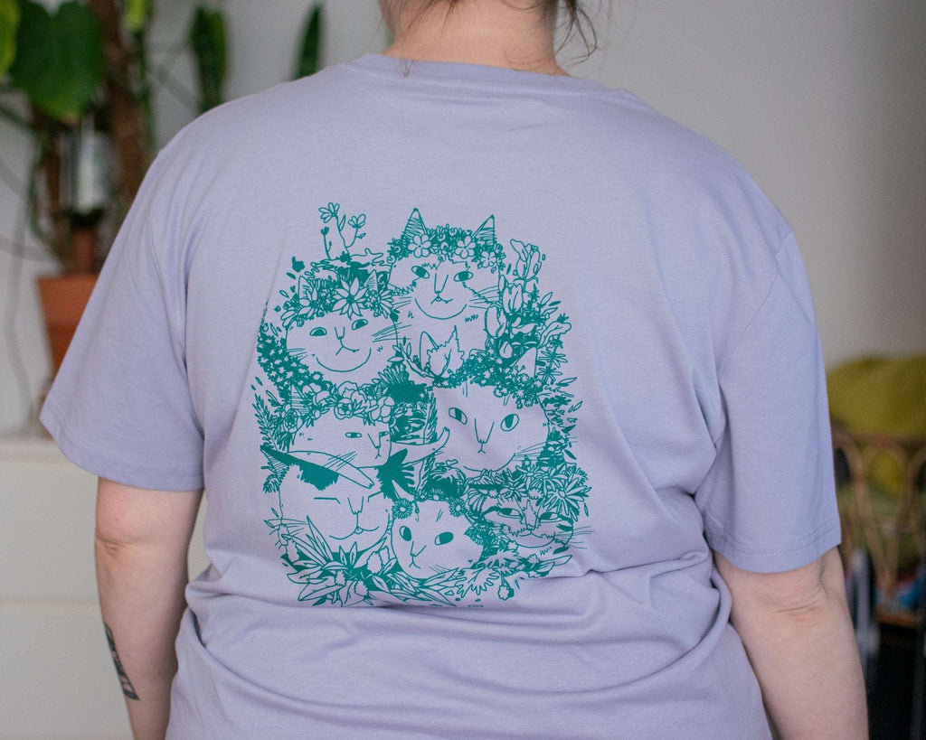 Summer Bouquet T-Shirt | Hand screen printed illustration of 7 cats with flowercrowns and other plants in green on lilac organic cotton tee