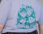 Summer Bouquet T-Shirt | Hand screen printed illustration of 7 cats with flowercrowns and other plants in green on lilac organic cotton tee