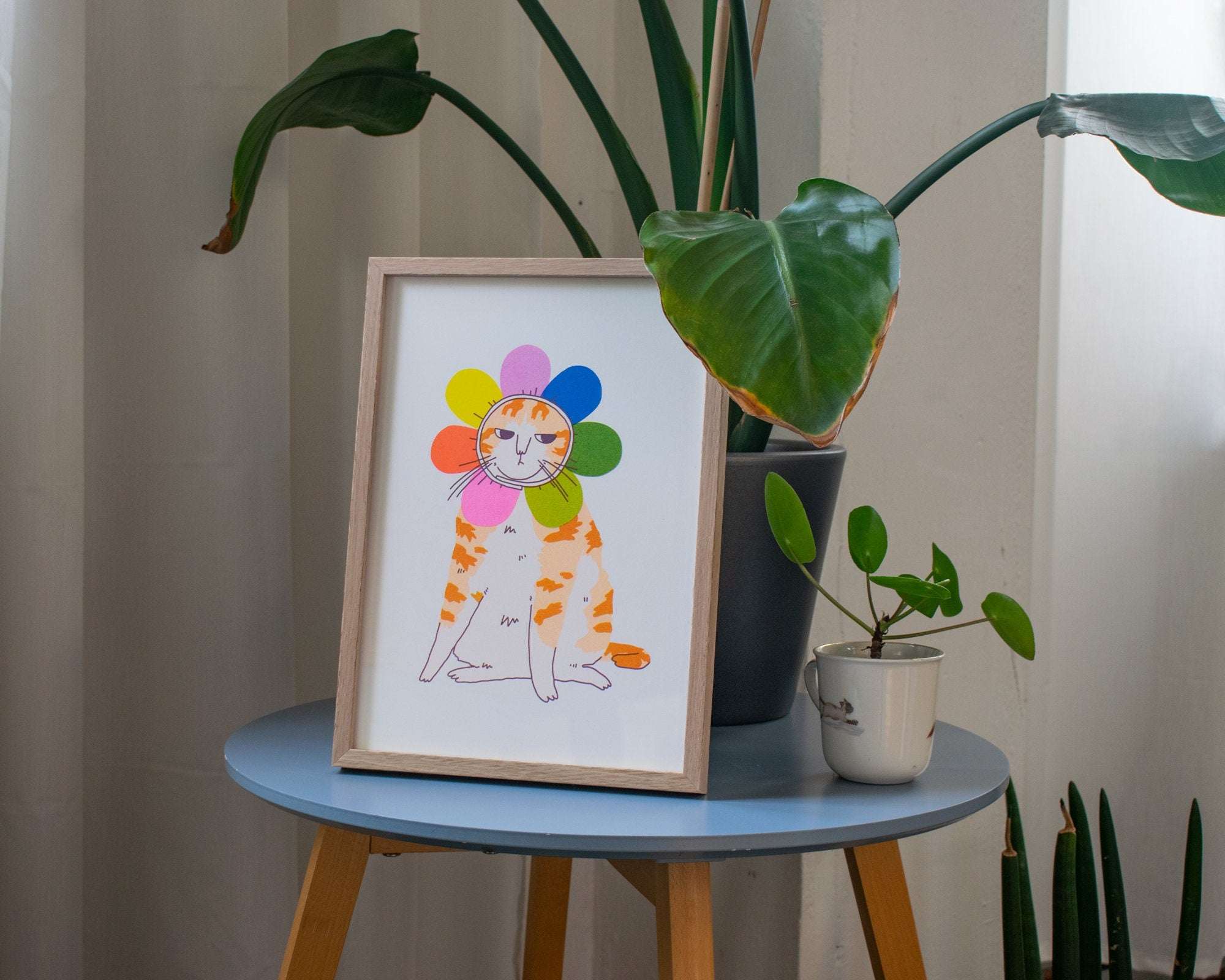 Grumpy Flower A4 Risograph poster | Illustration in fluorescent pink, blue and yellow of an angry looking cat in a flower costume