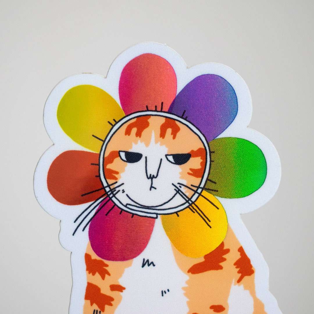 Grumpy Flower Cat | Holographic vinyl sticker of a irritable orange tabby cat wearing a rainbow colored flower petal costume around its head