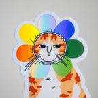 Grumpy Flower Cat | Holographic vinyl sticker of a irritable orange tabby cat wearing a rainbow colored flower petal costume around its head