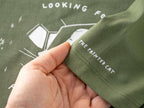 T-shirt: Looking for f***s to give | Hand screen printed olive green organic cotton tee with white illustration of a cat with binoculars