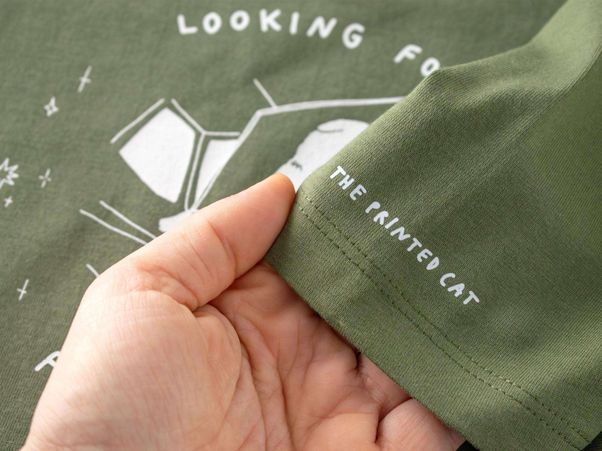 T-shirt: Looking for f***s to give | Hand screen printed olive green organic cotton tee with white illustration of a cat with binoculars