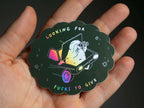 Looking for fucks to give 2.0 | Holographic Cat Sticker of a cat sitting in the trunk of a car looking for f***s to give through binoculars
