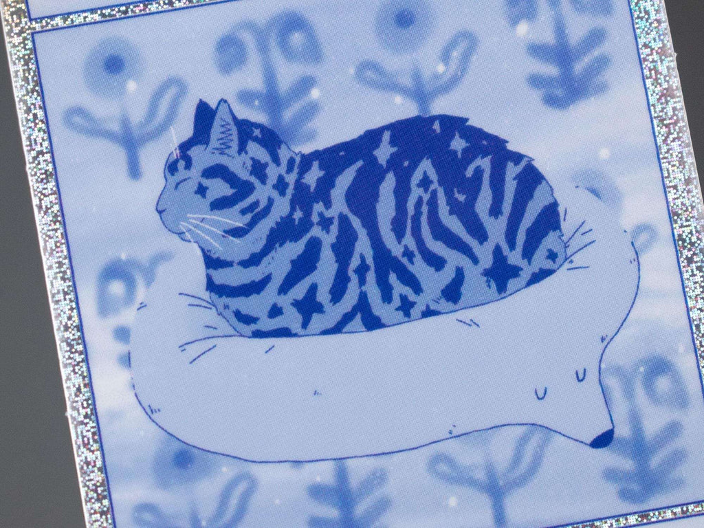 Bliss 2.0 | Pixie dust vinyl sticker with comic style illustration of a tabby cat getting comfy for your phone, laptop or water bottle