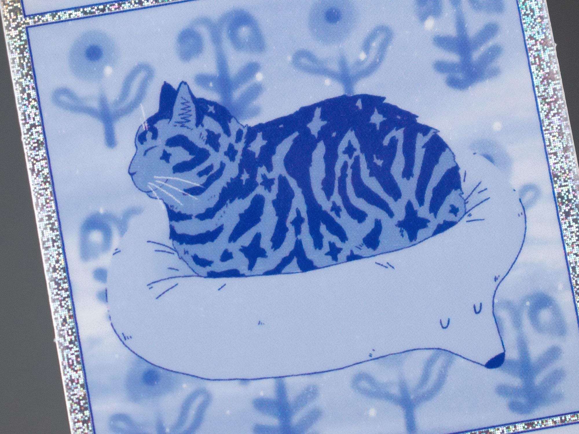 Bliss 2.0 | Pixie dust vinyl sticker with comic style illustration of a tabby cat getting comfy for your phone, laptop or water bottle