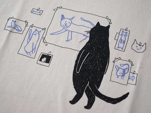 Cat gallery t-shirt | Hand screen printed on beige organic cotton tee with black and blue illustration of a cat judging his own art
