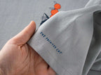 Orange Cat t-shirt | Hand screen printed illustration of a cat balancing oranges on grey organic cotton tee with navy and orange