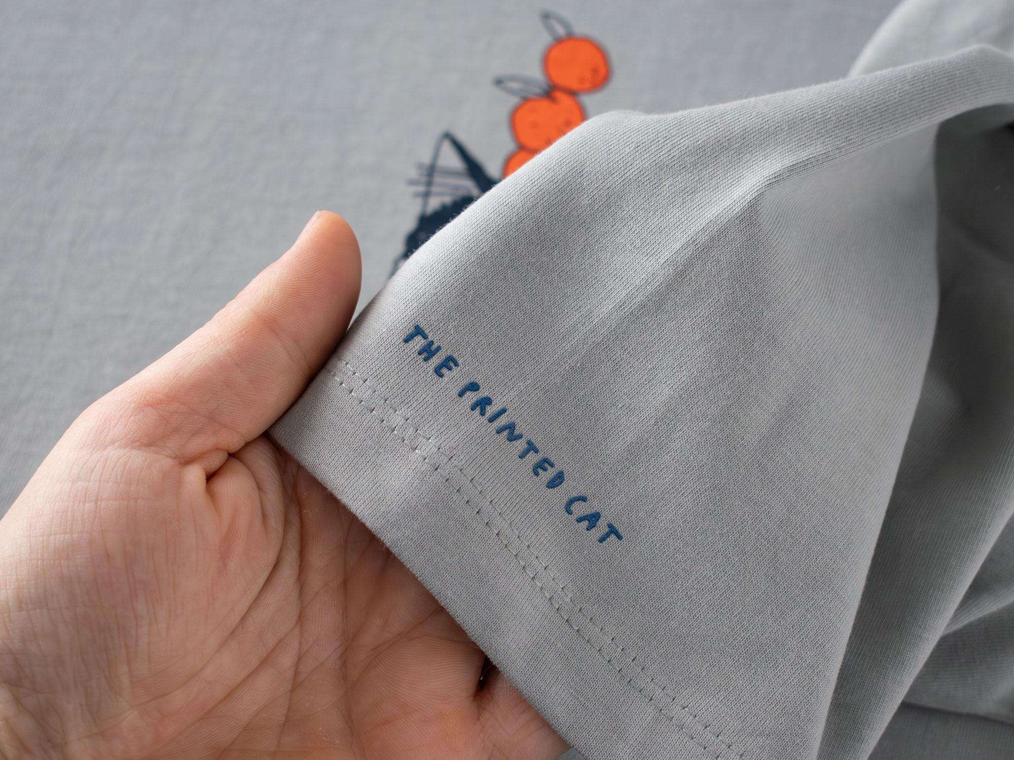 Orange Cat t-shirt | Hand screen printed illustration of a cat balancing oranges on grey organic cotton tee with navy and orange