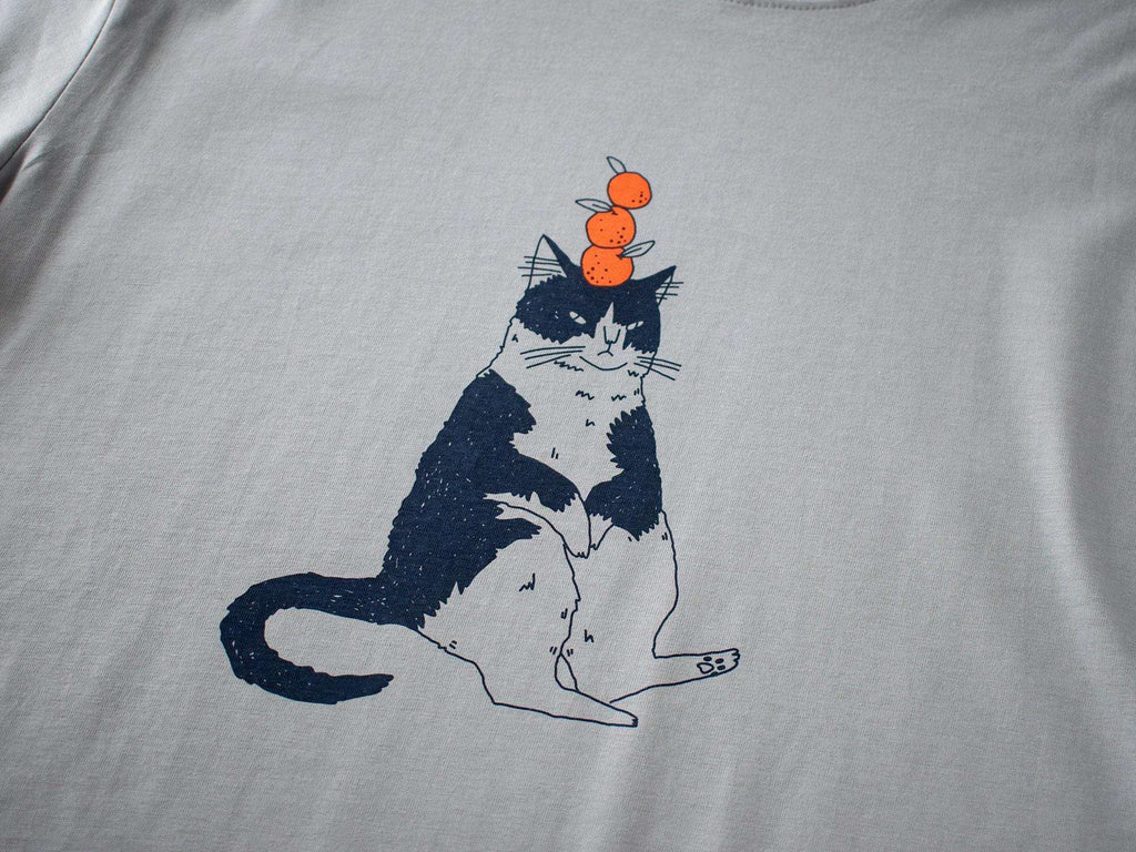 Orange Cat t-shirt | Hand screen printed illustration of a cat balancing oranges on grey organic cotton tee with navy and orange