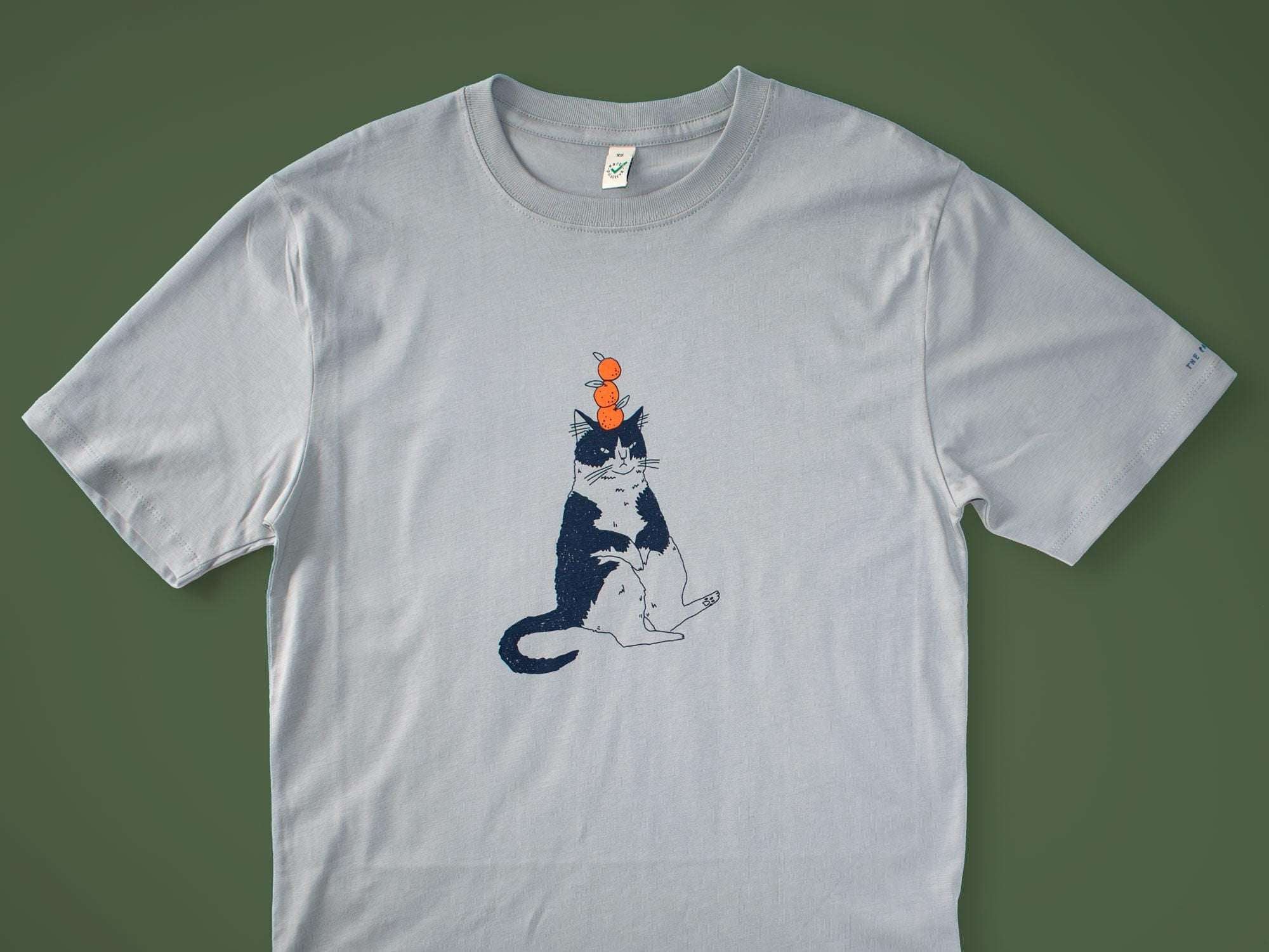 Orange Cat t-shirt | Hand screen printed illustration of a cat balancing oranges on grey organic cotton tee with navy and orange