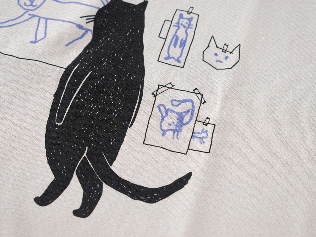 Cat gallery t-shirt | Hand screen printed on beige organic cotton tee with black and blue illustration of a cat judging his own art