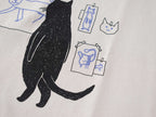 Cat gallery t-shirt | Hand screen printed on beige organic cotton tee with black and blue illustration of a cat judging his own art