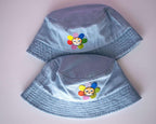Grumpy Flower Bucket Hat | Sky blue fishermans hat with dtf printed or embroiderd patch of a grumpy cat with rainbow flower around is neck