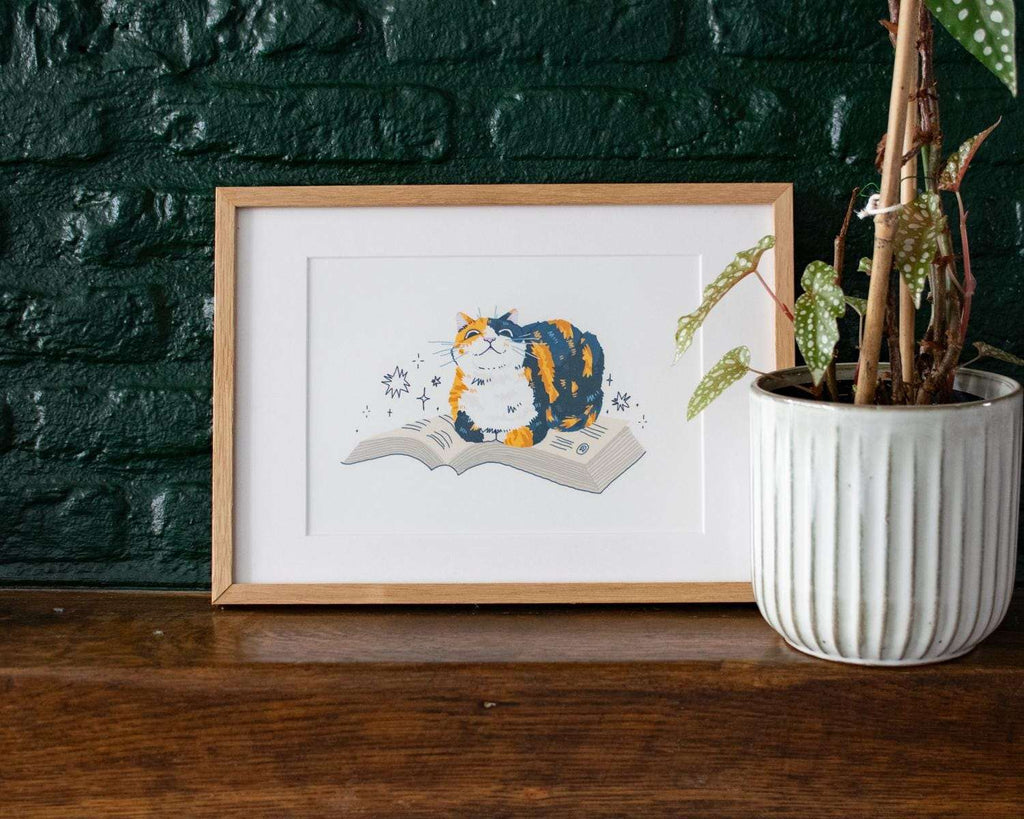 Read me | Giclée art print for bookish people of a calico cat sitting on a book