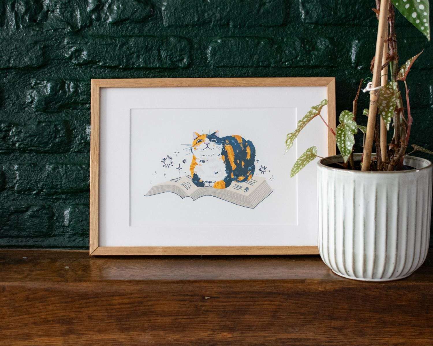 Read me | Giclée art print for bookish people of a calico cat sitting on a book
