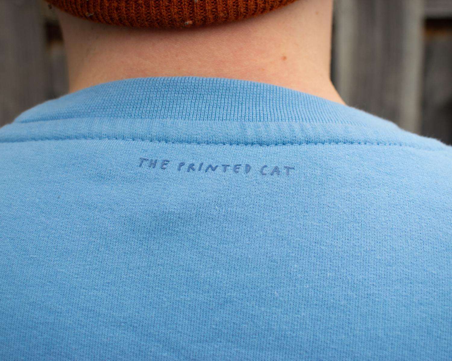 Reflecting eyes sweatshirt with a hand screen printed illustration of a bunch of cats in the dark