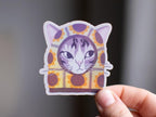 Sunflower Balaclava Cat | Cute holographic vinyl sticker of a purple tabby cat wearing a balaclava with flowers on it
