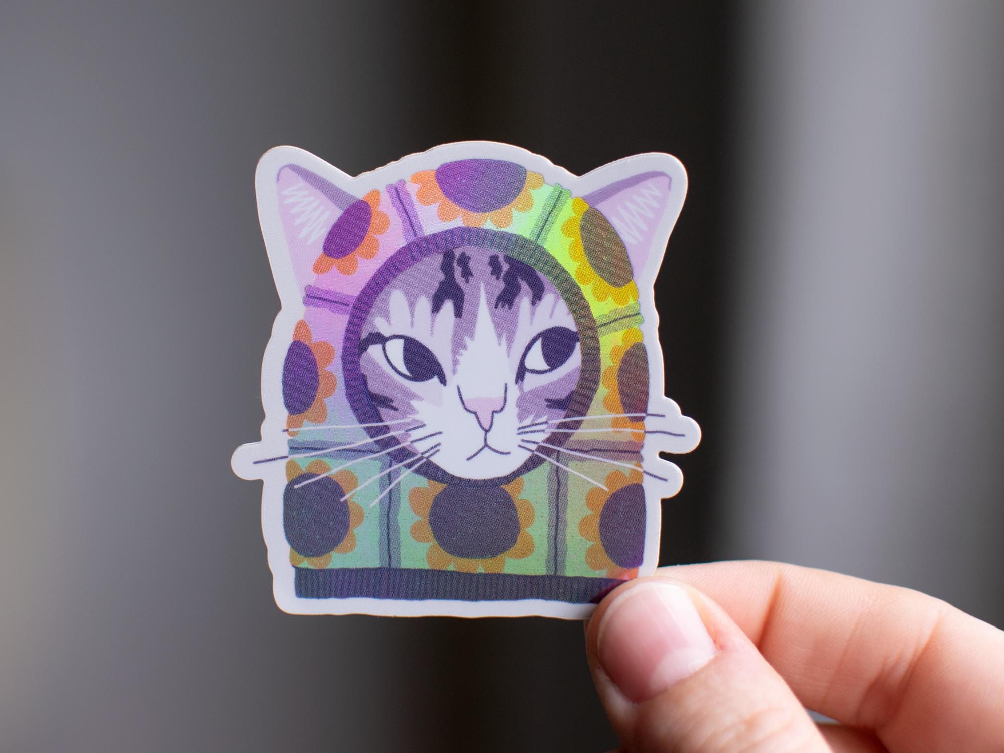 Sunflower Balaclava Cat | Cute holographic vinyl sticker of a purple tabby cat wearing a balaclava with flowers on it