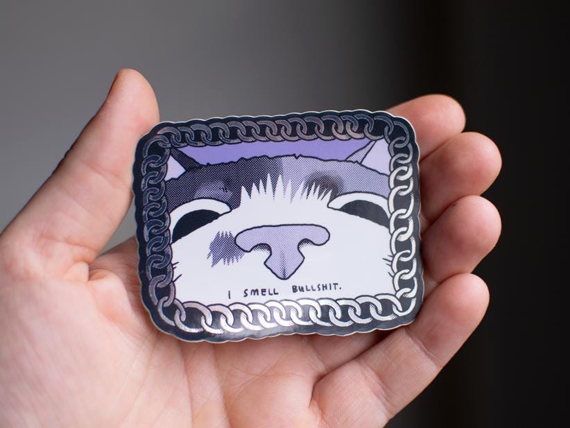 I smell bullshit | Funny chrome vinyl sticker of a cat that sniffs the viewer and calls out their bullshit framed with a silver chain