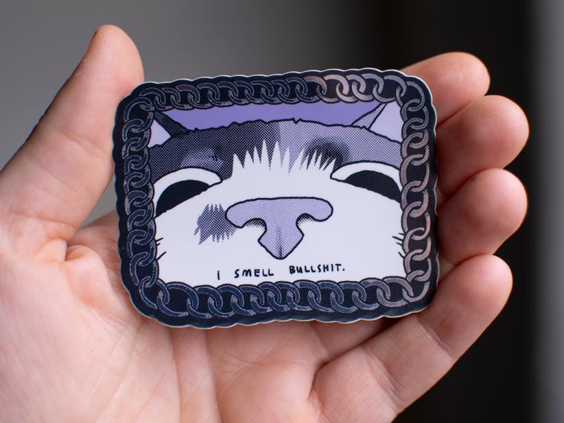 I smell bullshit | Funny chrome vinyl sticker of a cat that sniffs the viewer and calls out their bullshit framed with a silver chain