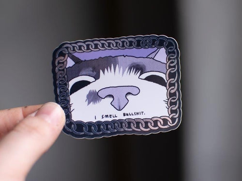 I smell bullshit | Funny chrome vinyl sticker of a cat that sniffs the viewer and calls out their bullshit framed with a silver chain