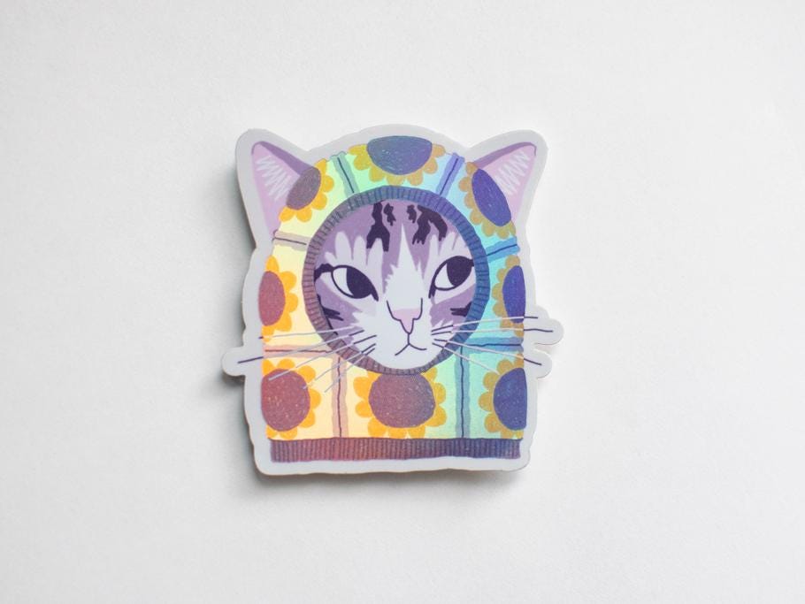 Sunflower Balaclava Cat | Cute holographic vinyl sticker of a purple tabby cat wearing a balaclava with flowers on it