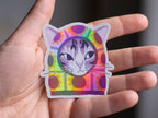 Sunflower Balaclava Cat | Cute holographic vinyl sticker of a purple tabby cat wearing a balaclava with flowers on it