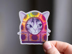 Sunflower Balaclava Cat | Cute holographic vinyl sticker of a purple tabby cat wearing a balaclava with flowers on it