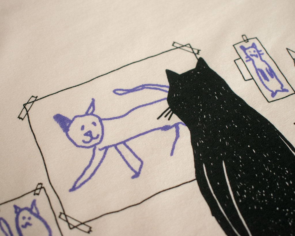 Cat gallery top | Hand screen printed on ecru organic cotton sleevless cropped top with black and blue illustration of a cat judging cat art