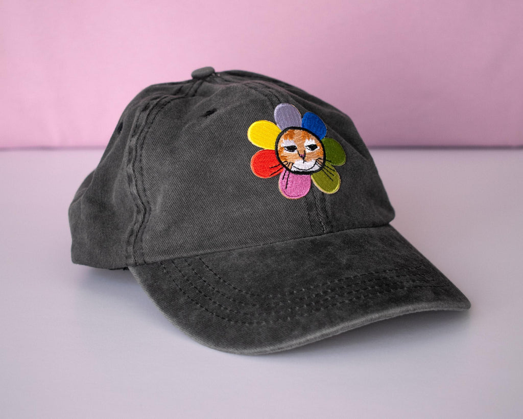 Grumpy Flower dad cap | Sky blue vintage style cap with embroiderd patch of a grumpy cat with rainbow flower around is neck