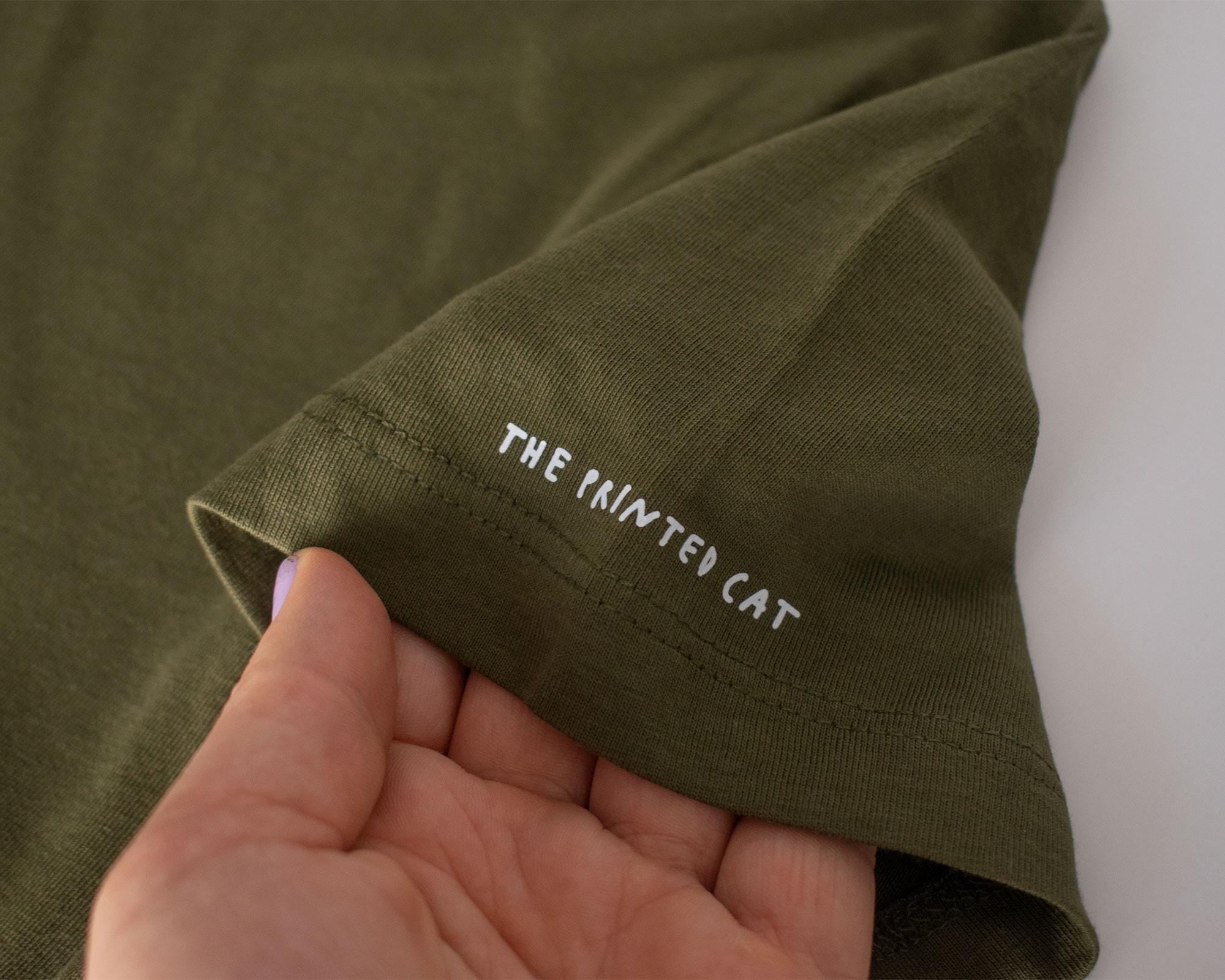 Looking for f***s to give crop top | Hand screen printed olive green 100% cotton tee with white illustration of a cat with binoculars
