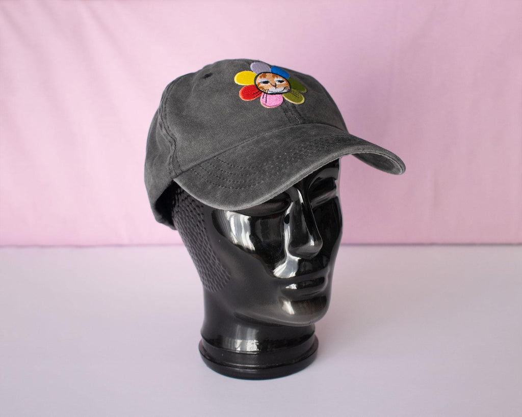 Grumpy Flower dad cap | Sky blue vintage style cap with embroiderd patch of a grumpy cat with rainbow flower around is neck