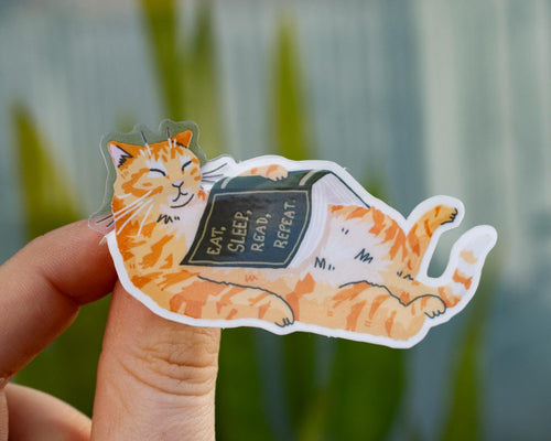Eat, sleep, read, repeat | Transparent cat Sticker for bookish people with a sleepy orange cat and a green book in its belly