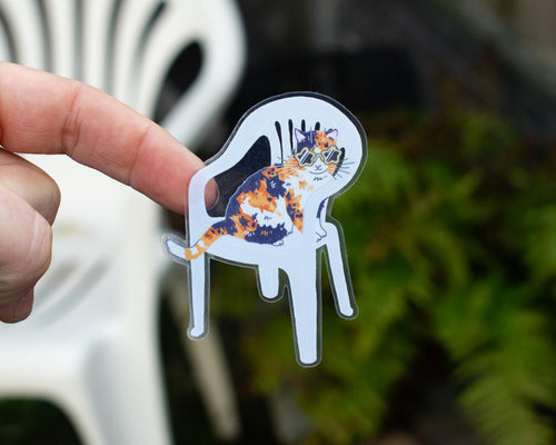 Calico Queen | Transparent cat sticker of a cat with sunglasses sitting on a plastic garden chair