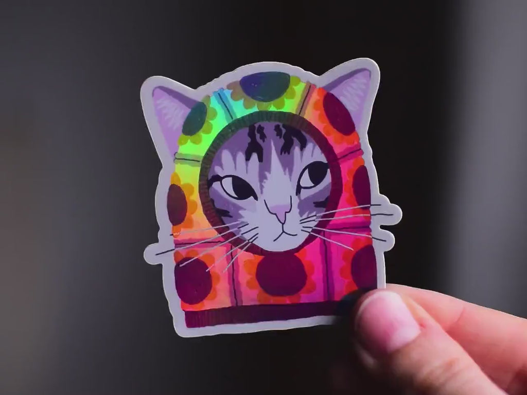 Sunflower Balaclava Cat | Cute holographic vinyl sticker of a purple tabby cat wearing a balaclava with flowers on it