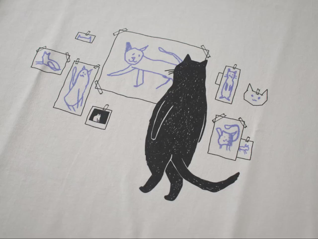 Cat gallery t-shirt | Hand screen printed on beige organic cotton tee with black and blue illustration of a cat judging his own art